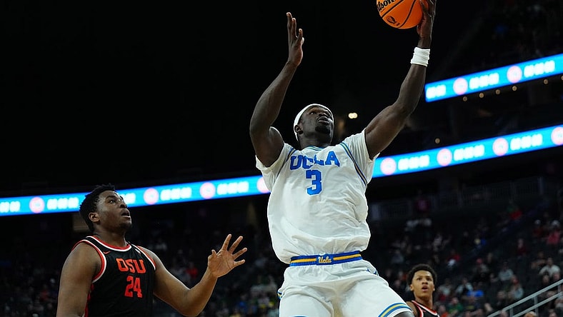 Mar 13, 2024; Las Vegas, NV, USA; UCLA Bruins forward Adem Bona (3) catches the ball against Oregon State Beavers center KC Ibekwe (24) in the first half at T-Mobile Arena. Mandatory Credit: Kirby Lee-USA TODAY Sports