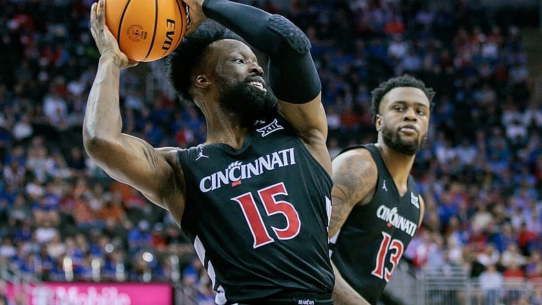 Mar 13, 2024; Kansas City, MO, USA; Cincinnati Bearcats forward John Newman III (15) grabs the rebound during the first half against the Kansas Jayhawks at T-Mobile Center. Mandatory Credit: William Purnell-USA TODAY Sports