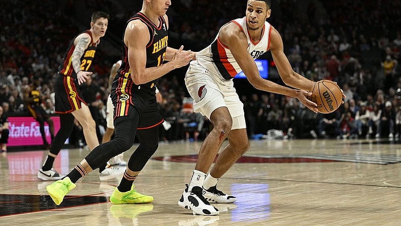 Mar 13, 2024; Portland, Oregon, USA; Portland Trail Blazers forward Kris Murray (8) looks for an opening during the first half against Atlanta Hawks guard Bogdan Bogdanovic (13) at Moda Center. Mandatory Credit: Troy Wayrynen-USA TODAY Sports