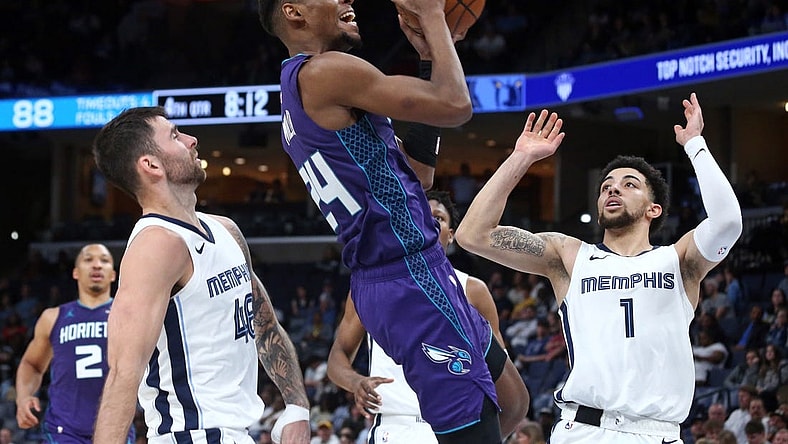 Mar 12, 2024; Memphis, Tennessee, USA; Charlotte Hornets forward Brandon Miller (24) drives to the basket between Memphis Grizzlies guard John Konchar (46) and guard Scotty Pippen Jr. (1)  during the second half at FedExForum. Mandatory Credit: Petre Thomas-USA TODAY Sports