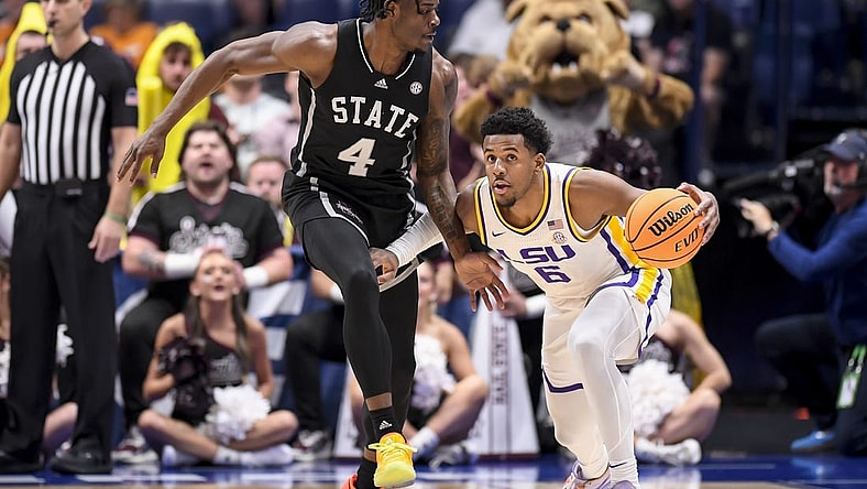 Mar 14, 2024; Nashville, TN, USA; LSU Tigers guard Jordan Wright (6) dribbles as Mississippi State Bulldogs forward Cameron Matthews (4) guards during the first half at Bridgestone Arena. Mandatory Credit: Steve Roberts-USA TODAY Sports