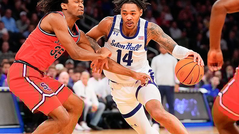 Mar 14, 2024; New York City, NY, USA;  Seton Hall Pirates guard Dre Davis (14) drives on St. John's Red Storm forward Glenn Taylor Jr. (35) during the first half at Madison Square Garden. Mandatory Credit: Robert Deutsch-USA TODAY Sports