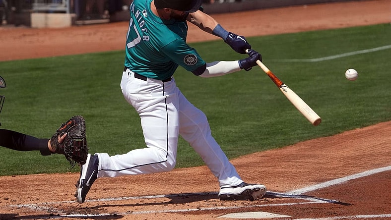 Mar 14, 2024; Peoria, Arizona, USA; Seattle Mariners left fielder Mitch Haniger (17) hits a solo home run against the Milwaukee Brewers during the first inning at Peoria Sports Complex. Mandatory Credit: Joe Camporeale-USA TODAY Sports