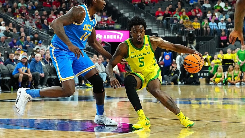 Mar 14, 2024; Las Vegas, NV, USA;Oregon Ducks guard Jermaine Couisnard (5) dribbles against UCLA Bruins forward Kenneth Nwuba (14) during the first half at T-Mobile Arena. Mandatory Credit: Stephen R. Sylvanie-USA TODAY Sports