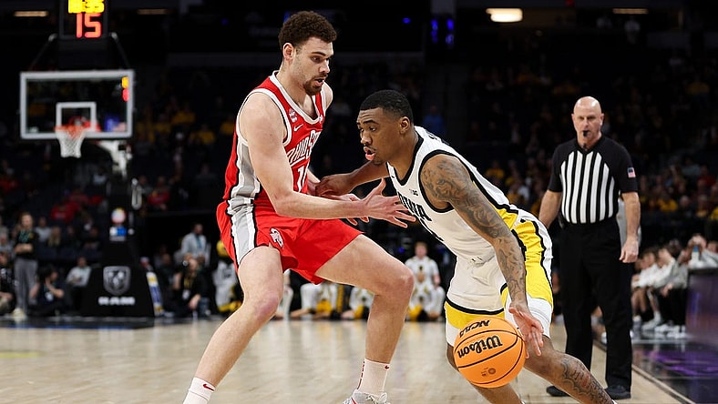Mar 14, 2024; Minneapolis, MN, USA; Iowa Hawkeyes guard Tony Perkins (11) dribbles around Ohio State Buckeyes forward Jamison Battle (10) during the first half at Target Center. Mandatory Credit: Matt Krohn-USA TODAY Sports