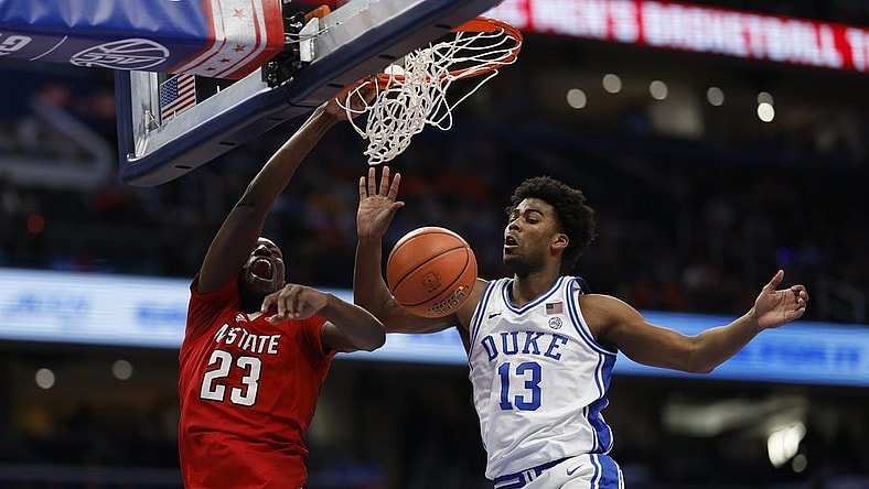 Mar 14, 2024; Washington, D.C., USA; North Carolina State forward Mohamed Diarra (23) dunks the ball as Duke Blue Devils forward Sean Stewart (13) defends in the first half at Capital One Arena. Mandatory Credit: Geoff Burke-USA TODAY Sports