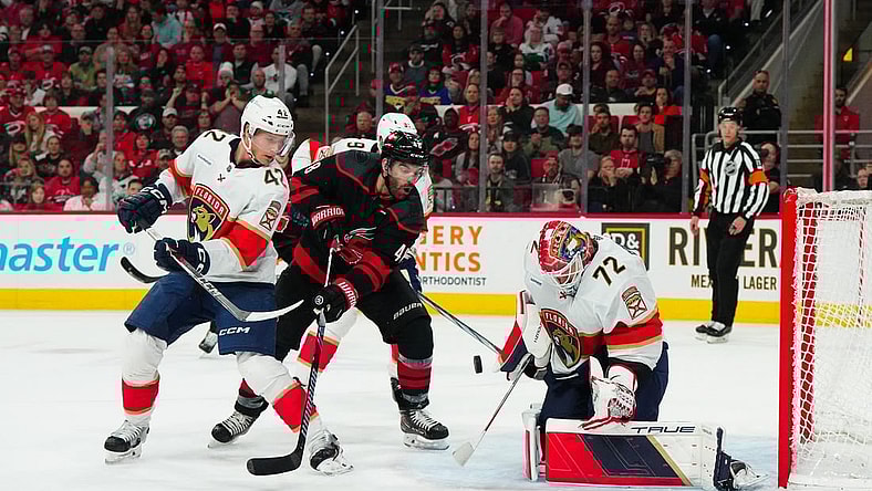 Mar 14, 2024; Raleigh, North Carolina, USA; Carolina Hurricanes left wing Jordan Martinook (48) shot attempt is stopped by Florida Panthers goaltender Sergei Bobrovsky (72) and defenseman Gustav Forsling (42) during the first period at PNC Arena. Mandatory Credit: James Guillory-USA TODAY Sports