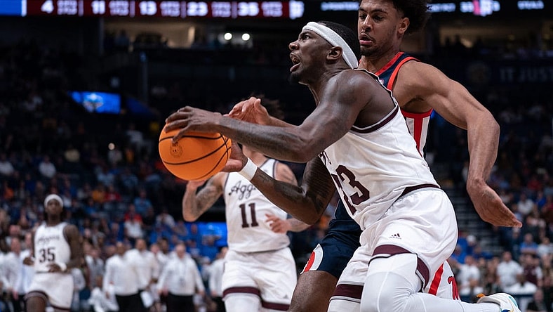 Texas A&M Aggies guard Tyrece Radford (23) drives to the bucket against Mississippi Rebels forward Jaemyn Brakefield (4) during their second round game of the SEC Men's Basketball Tournament at Bridgestone Arena in Nashville, Tenn., Thursday, March 14, 2024.