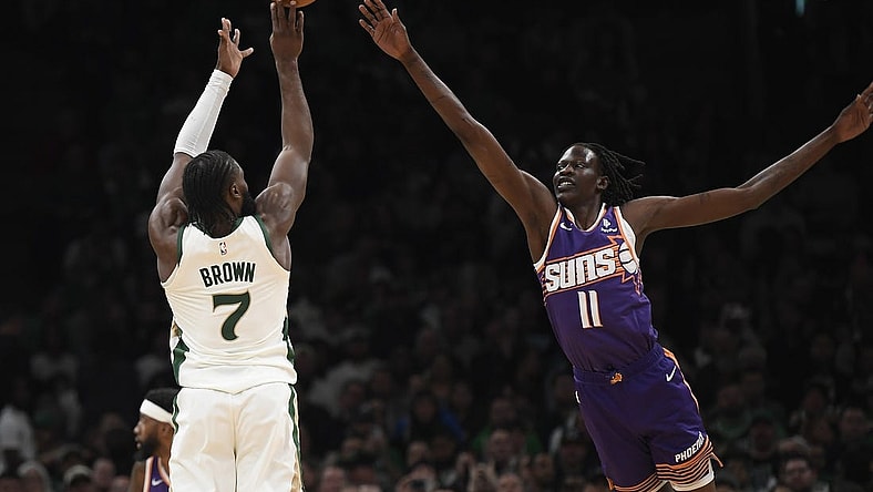 Mar 14, 2024; Boston, Massachusetts, USA;  Boston Celtics guard Jaylen Brown (7) shoots the ball over Phoenix Suns center Bol Bol (11) during the first half at TD Garden. Mandatory Credit: Bob DeChiara-USA TODAY Sports