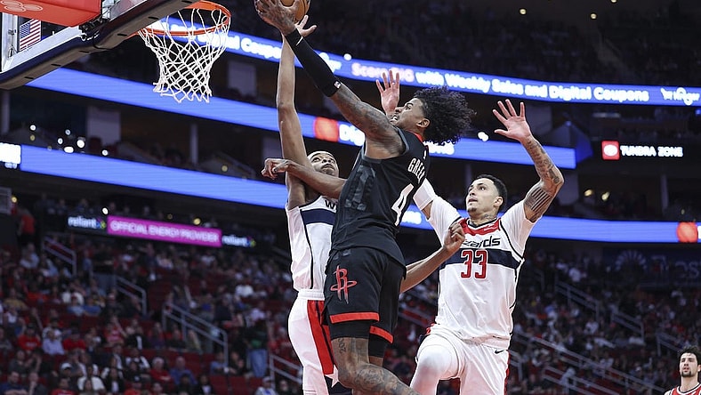 Mar 14, 2024; Houston, Texas, USA; Houston Rockets guard Jalen Green (4) drives to the basket as Washington Wizards guard Bilal Coulibaly (0) defends during the second quarter at Toyota Center. Mandatory Credit: Troy Taormina-USA TODAY Sports