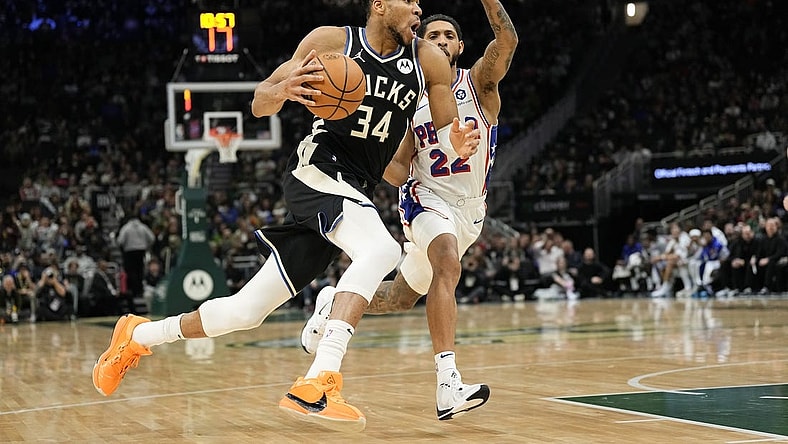 Mar 14, 2024; Milwaukee, Wisconsin, USA;  Milwaukee Bucks forward Giannis Antetokounmpo (34) drives for the basket in front of Philadelphia 76ers guard Cameron Payne (22) during the second quarter at Fiserv Forum. Mandatory Credit: Jeff Hanisch-USA TODAY Sports
