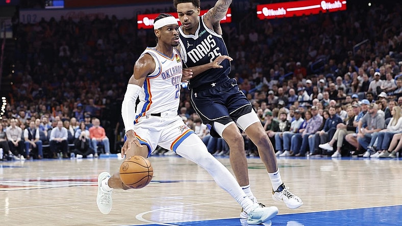 Mar 14, 2024; Oklahoma City, Oklahoma, USA; Oklahoma City Thunder guard Shai Gilgeous-Alexander (2) drives to the basket beside Dallas Mavericks forward P.J. Washington (25) during the second half at Paycom Center. Mandatory Credit: Alonzo Adams-USA TODAY Sports