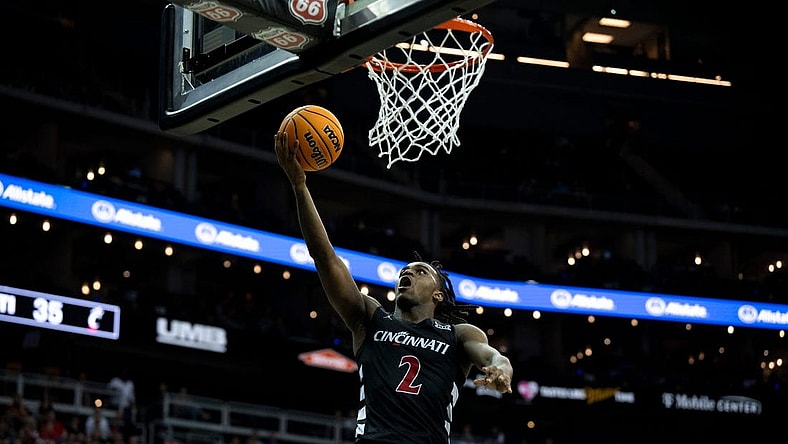 Cincinnati Bearcats guard Jizzle James (2) hits a layup in the second half of the Big 12 Conference tournament game between Cincinnati Bearcats and Baylor Bears at T-Mobile Center in Kansas City, Mo., on Thursday, March 14, 2024.