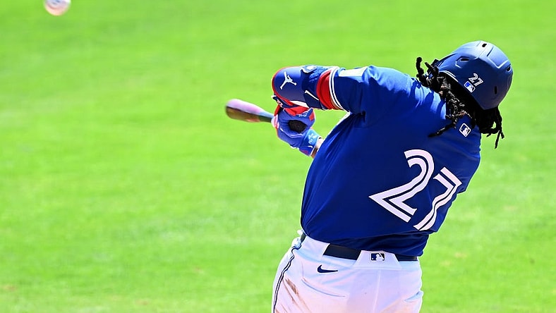 Mar 15, 2024; Dunedin, Florida, USA; Toronto Blue Jays first baseman Vladimir Guerrero Jr. (27) hits a line drive in the third inning of a spring training game against the Detroit Tigers at TD Ballpark. Mandatory Credit: Jonathan Dyer-USA TODAY Sports