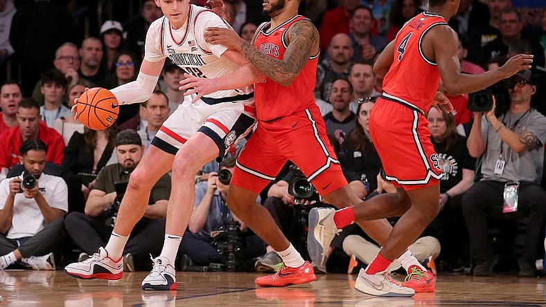 Mar 15, 2024; New York City, NY, USA; Connecticut Huskies center Donovan Clingan (32) controls the ball against St. John's Red Storm center Joel Soriano (11) and guard Nahiem Alleyne (4) during the first half at Madison Square Garden. Mandatory Credit: Brad Penner-USA TODAY Sports