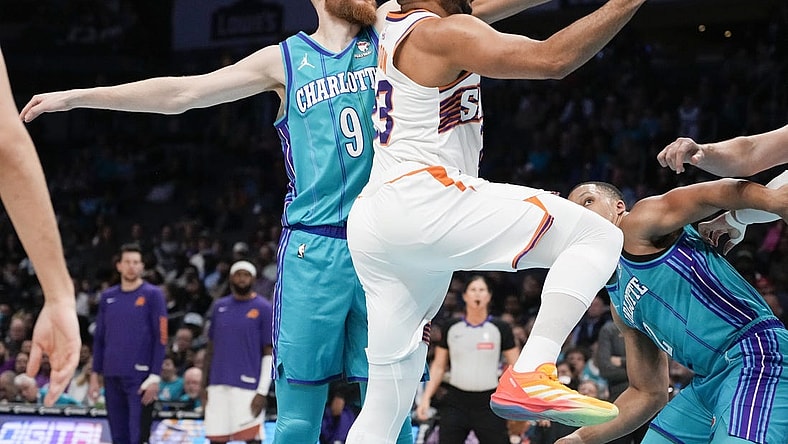 Mar 15, 2024; Charlotte, North Carolina, USA; Phoenix Suns guard Eric Gordon (23) drives to the basket against Charlotte Hornets forward Davis Bertans (9) during the first quarter at Spectrum Center. Mandatory Credit: Jim Dedmon-USA TODAY Sports