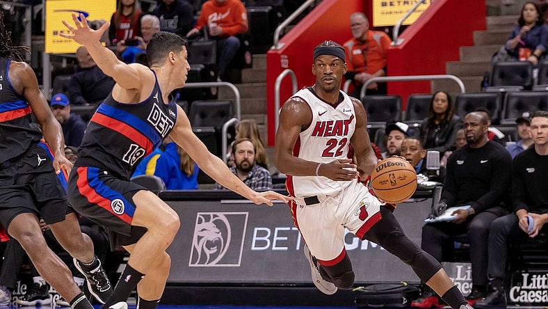 Mar 15, 2024; Detroit, Michigan, USA; Miami Heat forward Jimmy Butler (22) drives to the basket as Detroit Pistons forward Simone Fontecchio (19) defends during the first quarter at Little Caesars Arena. Mandatory Credit: David Reginek-USA TODAY Sports