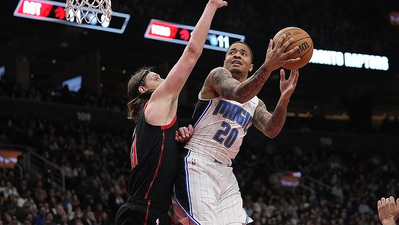 Mar 15, 2024; Toronto, Ontario, CAN; Toronto Raptors forward Kelly Olynyk (41) defends against Orlando Magic guard Markelle Fultz (20) during the first half at Scotiabank Arena. Mandatory Credit: John E. Sokolowski-USA TODAY Sports