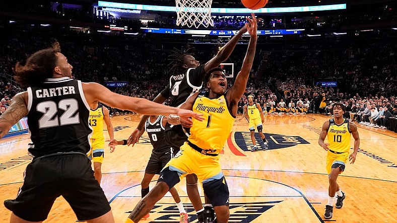 Mar 15, 2024; New York City, NY, USA;  Marquette Golden Eagles guard Kam Jones (1) shoots past Providence Friars guard Garwey Dual (3) during the first half at Madison Square Garden. Mandatory Credit: Robert Deutsch-USA TODAY Sports