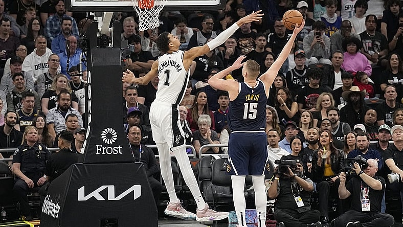 Mar 15, 2024; Austin, Texas, USA; Denver Nuggets center Nikola Jokic (15) shoots over San Antonio Spurs forward Victor Wembanyama (1) during the first half at Moody Center. Mandatory Credit: Scott Wachter-USA TODAY Sports