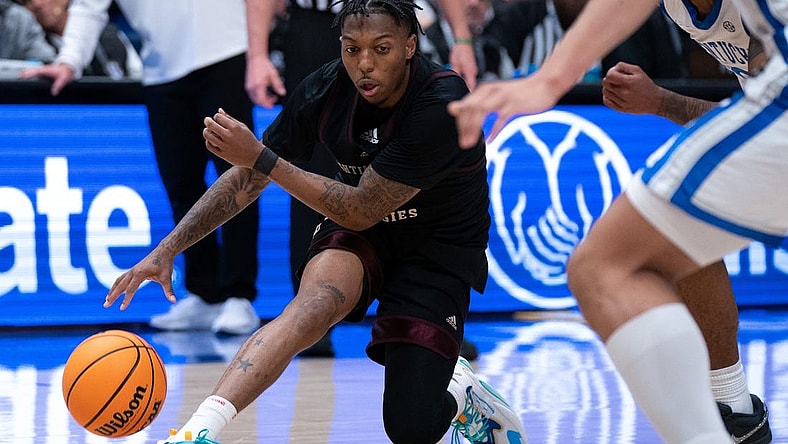 Texas A&M Aggies guard Wade Taylor IV (4) handles the ball against Kentucky during their SEC Men's Basketball Tournament quarterfinal game at Bridgestone Arena in Nashville, Tenn., Friday, March 15, 2024 at Bridgestone Arena in Nashville, Tenn., Friday, March 15, 2024.