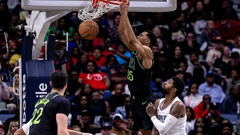 Mar 15, 2024; New Orleans, Louisiana, USA;  New Orleans Pelicans guard Trey Murphy III (25) dunks the ball against LA Clippers forward Paul George (13) during the second half at Smoothie King Center. Mandatory Credit: Stephen Lew-USA TODAY Sports