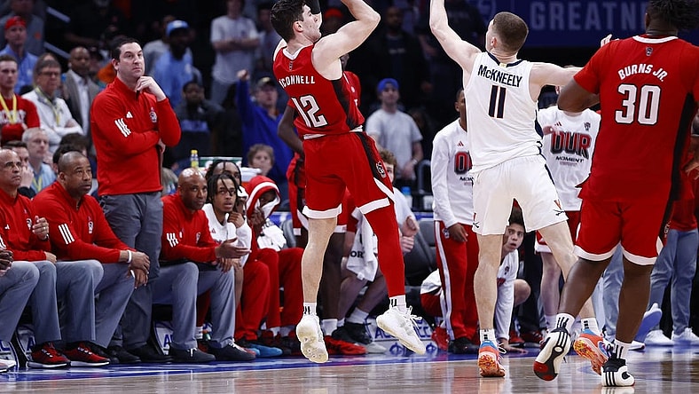 Mar 15, 2024; Washington, D.C., USA; North Carolina State Wolfpack guard Michael O'Connell (12) shoots a three point shot over Virginia Cavaliers guard Isaac McKneely (11) at the buzzer during the second half at Capital One Arena. Mandatory Credit: Amber Searls-USA TODAY Sports