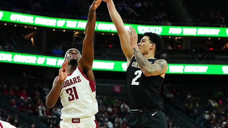 Mar 15, 2024; Las Vegas, NV, USA; Colorado Buffaloes guard KJ Simpson (2) shoots against Washington State Cougars guard Kymany Houinsou (31) during the first half at T-Mobile Arena. Mandatory Credit: Stephen R. Sylvanie-USA TODAY Sports