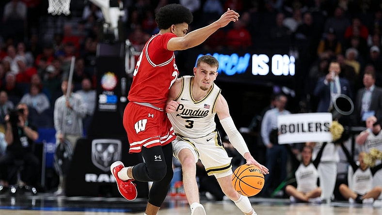 Mar 16, 2024; Minneapolis, MN, USA; Purdue Boilermakers guard Braden Smith (3) works up the court as Wisconsin Badgers guard Chucky Hepburn (23) defends during the first half at Target Center. Mandatory Credit: Matt Krohn-USA TODAY Sports