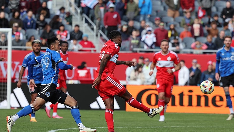 Mar 16, 2024; Chicago, Illinois, USA; Chicago Fire FC midfielder Kellyn Acosta (23) kicks the ball against CF Montreal midfielder Mathieu Choiniere (29) to score a long goal during the second half at Soldier Field. Mandatory Credit: Mike Dinovo-USA TODAY Sports
