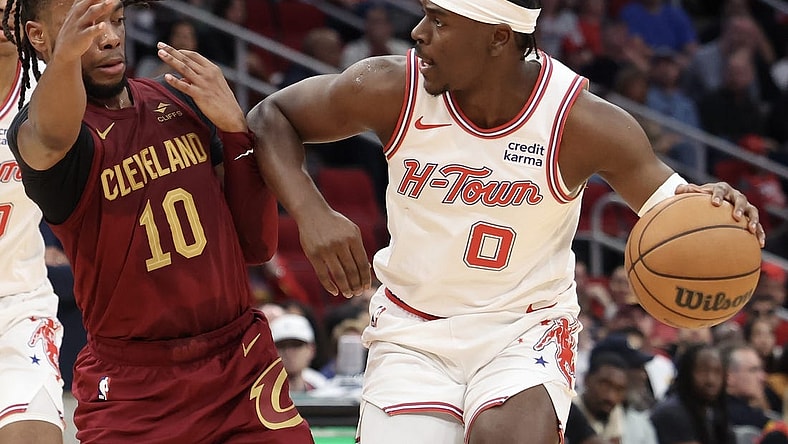 Mar 16, 2024; Houston, Texas, USA;  Houston Rockets guard Aaron Holiday (0) dribbles against Cleveland Cavaliers guard Darius Garland (10) in the second quarter at Toyota Center. Mandatory Credit: Thomas Shea-USA TODAY Sports