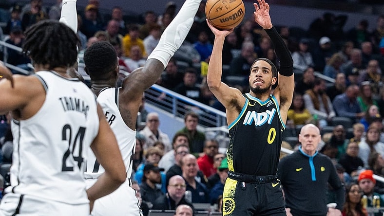 Mar 16, 2024; Indianapolis, Indiana, USA; Indiana Pacers guard Tyrese Haliburton (0) shoots the ball while Brooklyn Nets guard Dennis Schroder (17) defends in the first half at Gainbridge Fieldhouse. Mandatory Credit: Trevor Ruszkowski-USA TODAY Sports
