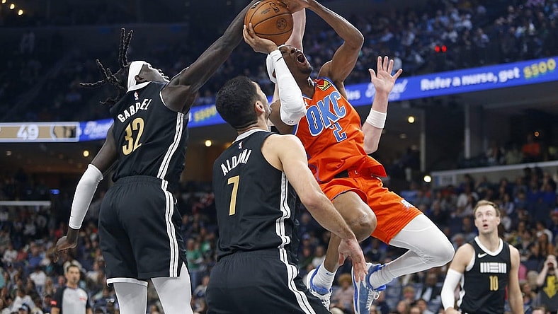 Mar 16, 2024; Memphis, Tennessee, USA; Oklahoma City Thunder guard Shai Gilgeous-Alexander (2) shoots as Memphis Grizzlies forward Wenyen Gabriel (32) defends during the first half at FedExForum. Mandatory Credit: Petre Thomas-USA TODAY Sports