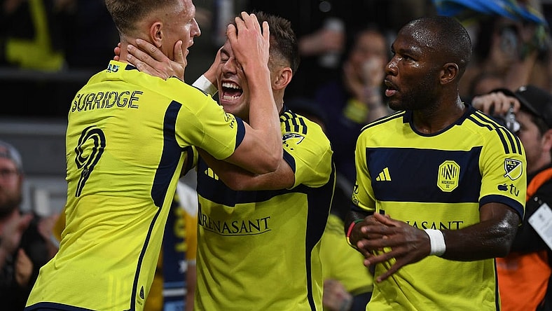 Mar 16, 2024; Nashville, Tennessee, USA; Nashville SC forward Sam Surridge (9) celebrates with defender Taylor Washington (23) after a goal during the first half against Charlotte FC at Geodis Park. Mandatory Credit: Christopher Hanewinckel-USA TODAY Sports