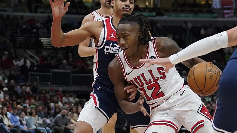 Mar 16, 2024; Chicago, Illinois, USA; Washington Wizards guard Jordan Poole (13) defends Chicago Bulls guard Ayo Dosunmu (12) during the first quarter at United Center. Mandatory Credit: David Banks-USA TODAY Sports