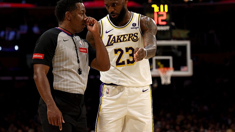 Mar 16, 2024; Los Angeles, California, USA; Los Angeles Lakers forward LeBron James (23) talks to referee Mitchell Ervin (27) during the second quarter against the Golden State Warriors at Crypto.com Arena. Mandatory Credit: Jason Parkhurst-USA TODAY Sports
