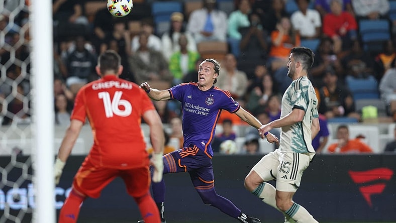 Mar 16, 2024; Houston, Texas, USA; Houston Dynamo FC midfielder Griffin Dorsey (25) runs after the ball against Portland Timbers defender Eric Miller (15) in the first half at Shell Energy Stadium. Mandatory Credit: Troy Taormina-USA TODAY Sports