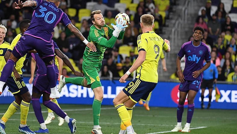 Mar 16, 2024; Nashville, Tennessee, USA; Nashville SC goalkeeper Joe Willis (1) catches the ball on a corner kick during the second half against Charlotte FC at Geodis Park. Mandatory Credit: Christopher Hanewinckel-USA TODAY Sports