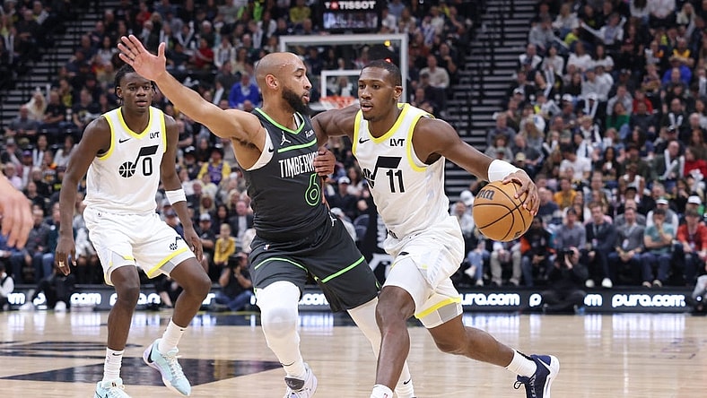 Mar 16, 2024; Salt Lake City, Utah, USA; Utah Jazz guard Kris Dunn (11) drives against Minnesota Timberwolves guard Jordan McLaughlin (6) during the second quarter at Delta Center. Mandatory Credit: Rob Gray-USA TODAY Sports