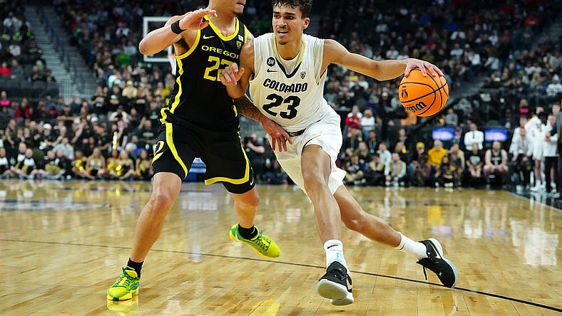 Mar 16, 2024; Las Vegas, NV, USA; Colorado Buffaloes forward Tristan da Silva (23) dribbles against Oregon Ducks guard Jadrian Tracey (22) during the first half at T-Mobile Arena. Mandatory Credit: Stephen R. Sylvanie-USA TODAY Sports