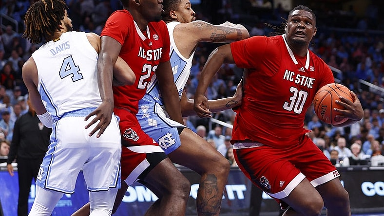 Mar 16, 2024; Washington, D.C., USA; North Carolina State Wolfpack forward DJ Burns Jr. (30) attempts to shoot the ball against the North Carolina Tar Heels during the second half at Capital One Arena. Mandatory Credit: Amber Searls-USA TODAY Sports