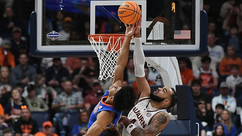 Mar 17, 2024; Nashville, TN, USA; Auburn Tigers forward Johni Broome (4) blocks Florida Gators guard Zyon Pullin (0) in the first half in the SEC Tournament championship game at Bridgestone Arena. Mandatory Credit: Christopher Hanewinckel-USA TODAY Sports