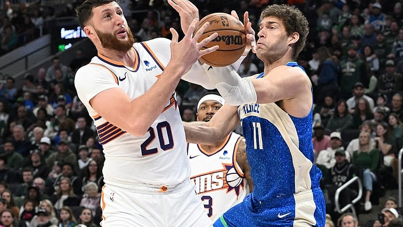 Mar 17, 2024; Milwaukee, Wisconsin, USA; Phoenix Suns center Jusuf Nurkic (20) and Milwaukee Bucks center Brook Lopez (11) battle for possession of the ball in the first half at Fiserv Forum. Mandatory Credit: Michael McLoone-USA TODAY Sports