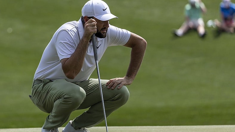 Mar 17, 2024; Ponte Vedra Beach, Florida, USA; Scottie Scheffler lines up a putt on the 3rd green during the final round of THE PLAYERS Championship golf tournament. Mandatory Credit: David Yeazell-USA TODAY Sports