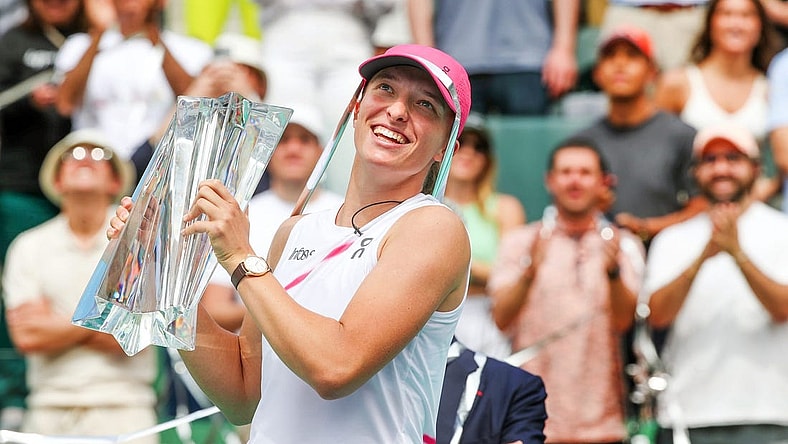 Iga Swiatek holds the BNP Paribas Open championship trophy after defeating Maria Sakkari 6-4, 6-0 at the Indian Wells Tennis Garden in Indian Wells, Calif., on Sunday, March 17, 2024.