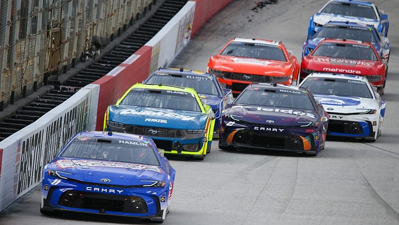 Mar 16, 2024; Bristol, Tennessee, USA; NASCAR Cup Series driver Denny Hamlin (11) leads driver Ryan Blaney (12) during the Food City 500 at Bristol Motor Speedway. Mandatory Credit: Randy Sartin-USA TODAY Sports