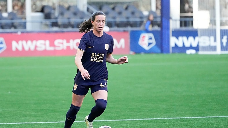 Mar 17, 2024; Seattle, Washington, USA; Seattle Reign defender Phoebe McClernon (21) dribbles against the Washington Spirit during the first half at Lumen Field. Mandatory Credit: Stephen Brashear-USA TODAY Sports