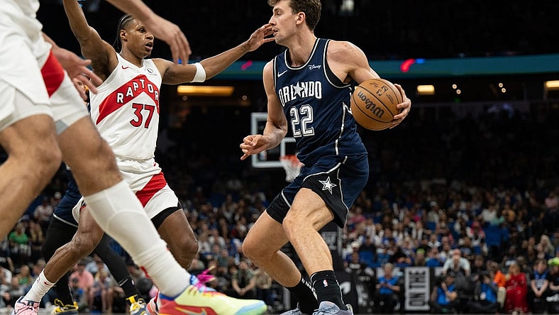 Mar 17, 2024; Orlando, Florida, USA; Orlando Magic forward Franz Wagner (22) dribbles the ball against Toronto Raptors guard Jamie'us Ramsey (37) in the second quarter at KIA Center. Mandatory Credit: Jeremy Reper-USA TODAY Sports