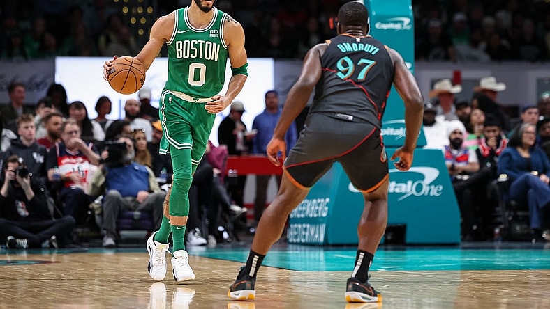 Mar 17, 2024; Washington, District of Columbia, USA; Boston Celtics forward Jayson Tatum (0) brings the ball up court against Washington Wizards forward Eugene Omoruyi (97) during the first half of the game at Capital One Arena. Mandatory Credit: Scott Taetsch-USA TODAY Sports