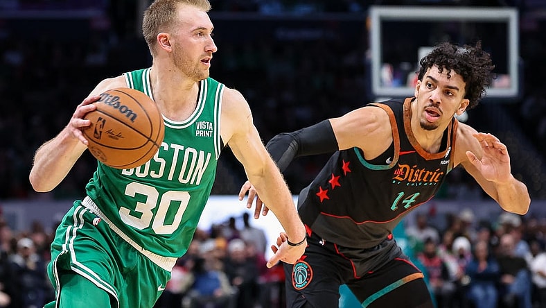 Mar 17, 2024; Washington, District of Columbia, USA; Boston Celtics forward Sam Hauser (30) drives to the basket against Washington Wizards guard Jules Bernard (14) during the first half of the game at Capital One Arena. Mandatory Credit: Scott Taetsch-USA TODAY Sports